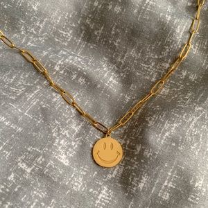 Gold smiley face necklace